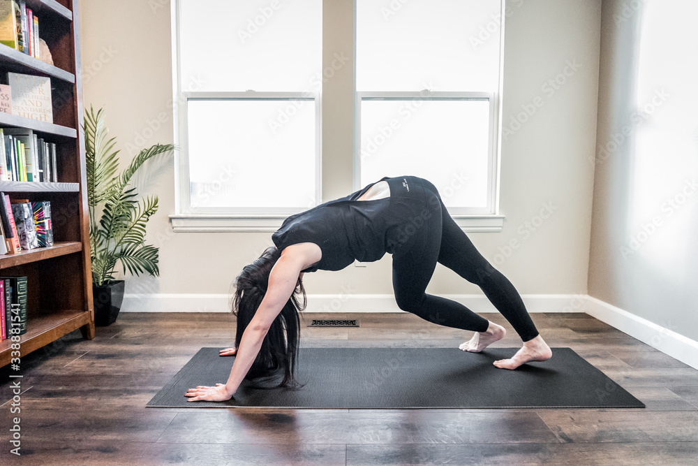 Woman doing yoga indoors at home