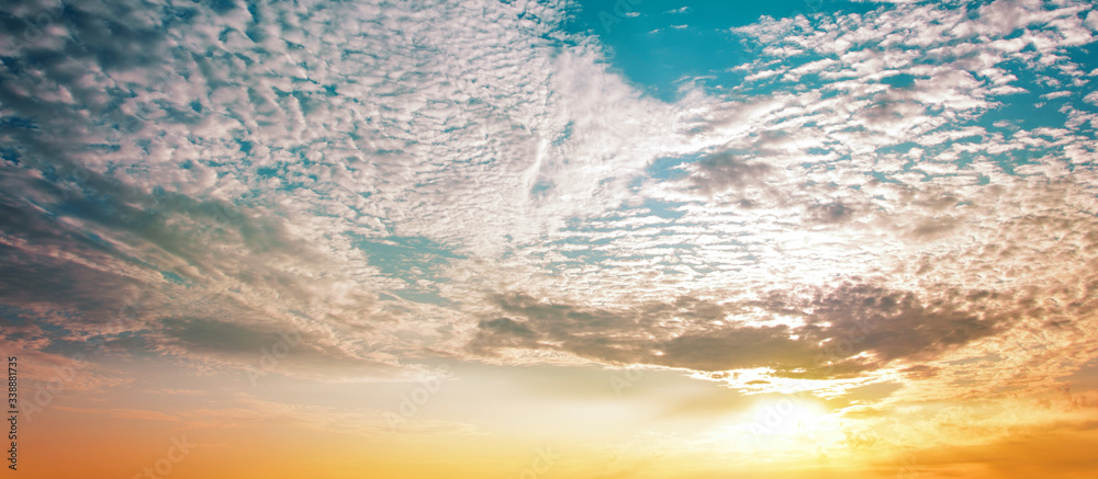 Beautiful sunset sky background with clouds. Banner.