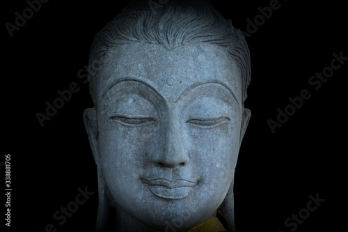 Mystical Buddha statue's face, face of ancient stone Buddha statue
