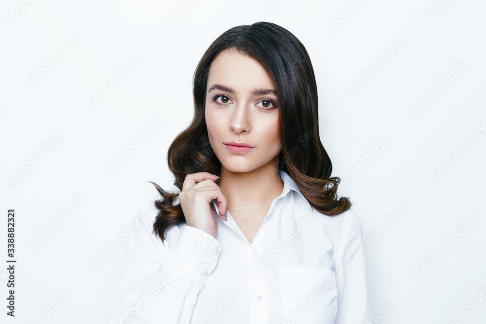 Pretty young brunette woman posing against white studio background Pretty young brunette woman posing against white studio background