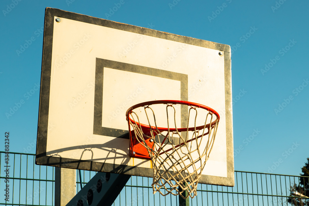 Basketball basket on the street against the blue sky Basketball basket on the street against the blue sky
