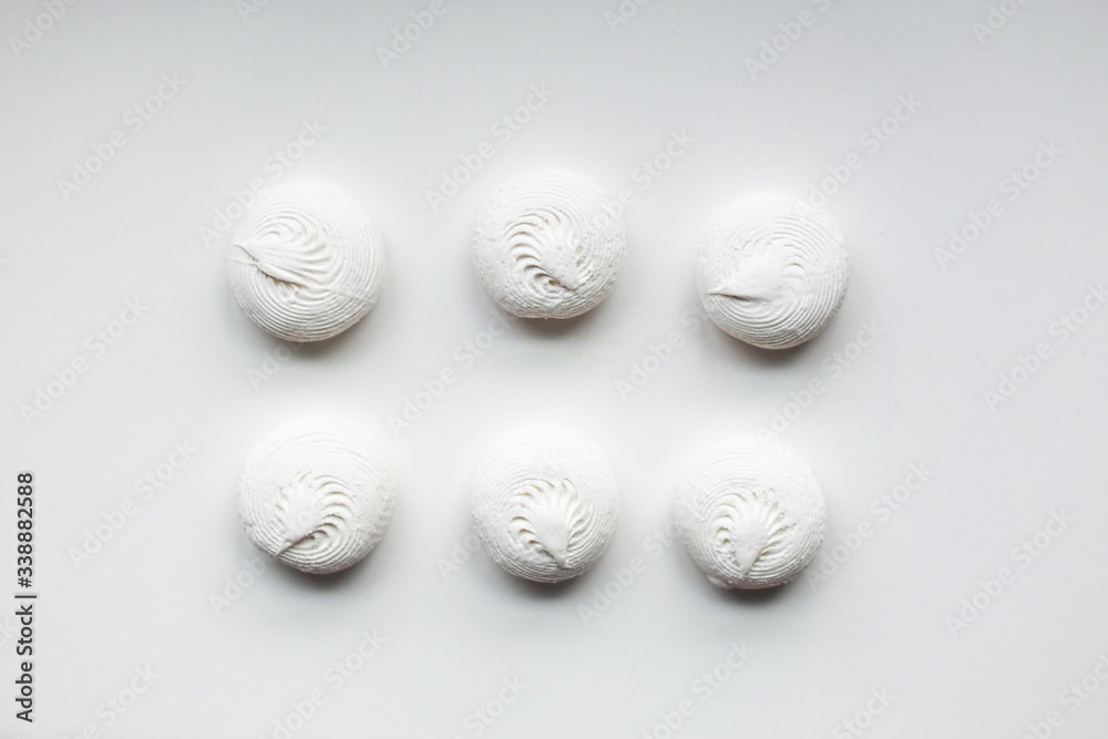 White sweet dessert zephyr marshmallows on white background. Confectionery. Even, organized, simple. White sweet dessert zephyr marshmallows on white background. Confectionery. Even, organized, simple.