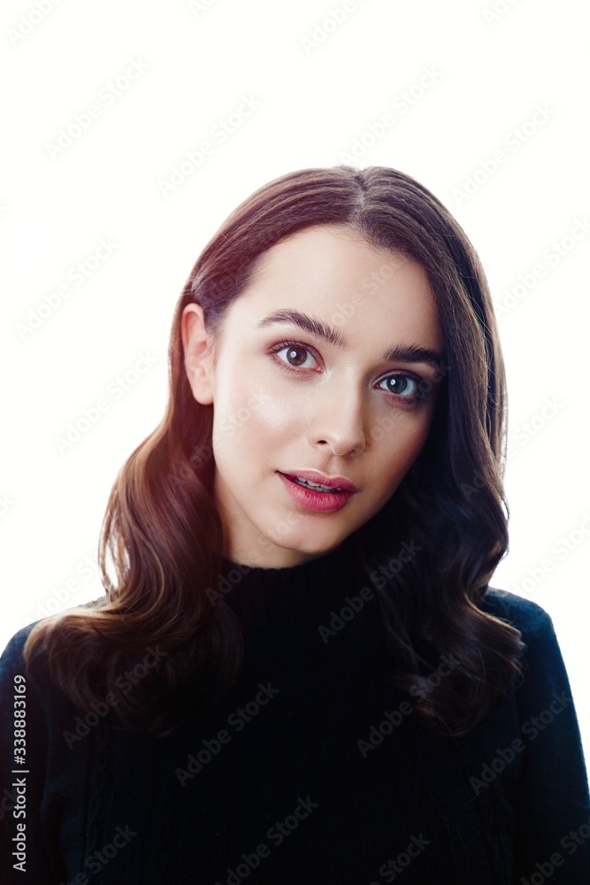 Fototapeta premium Pretty young brunette woman posing against white studio background 