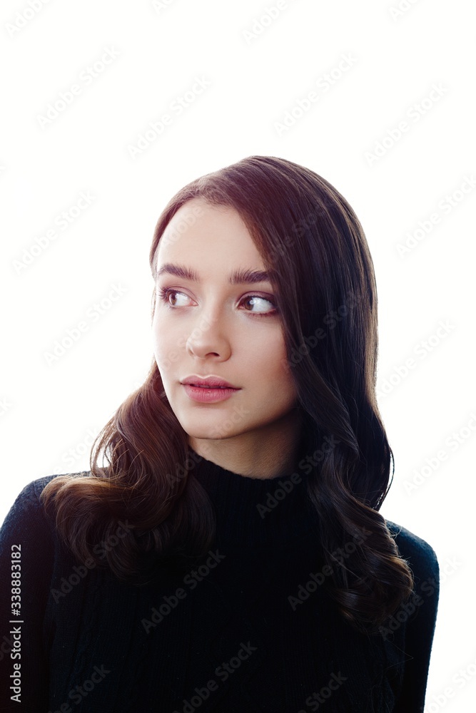Fototapeta premium Pretty young brunette woman posing against white studio background 