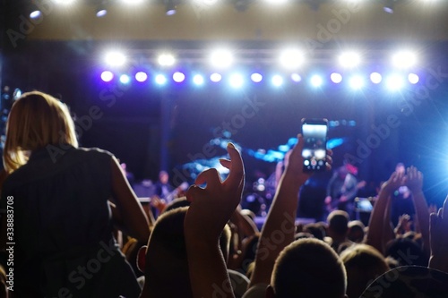 People having fun at a rock concert at night.