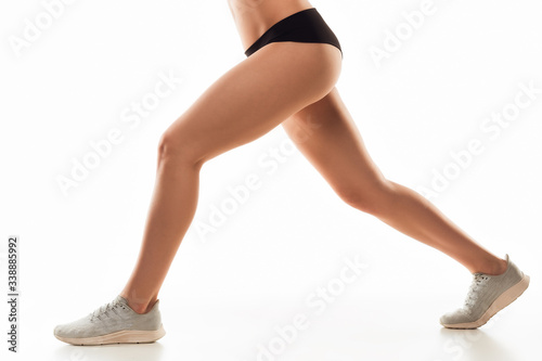 Beautiful female legs and butt isolated on white background. Beauty, cosmetics, spa, depilation, treatment and fitness concept. Fit and sportive, sensual body with well-kept skin in underwear