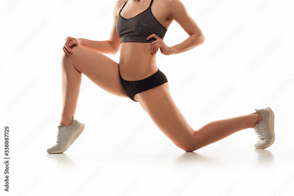 Beautiful female legs and belly on white background. Beauty, cosmetics, spa, depilation, treatment and fitness concept. Fit and sportive, sensual body with well-kept skin in underwear. Training.