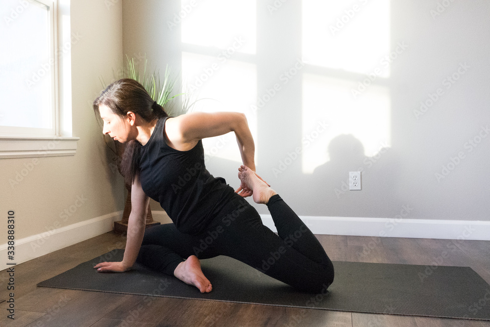 Women doing yoga indoors in home Women doing yoga indoors in home