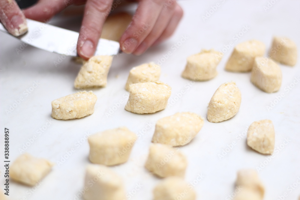 Gnocchi being prepared. Cutting dough. Dough dumplings with cheese.