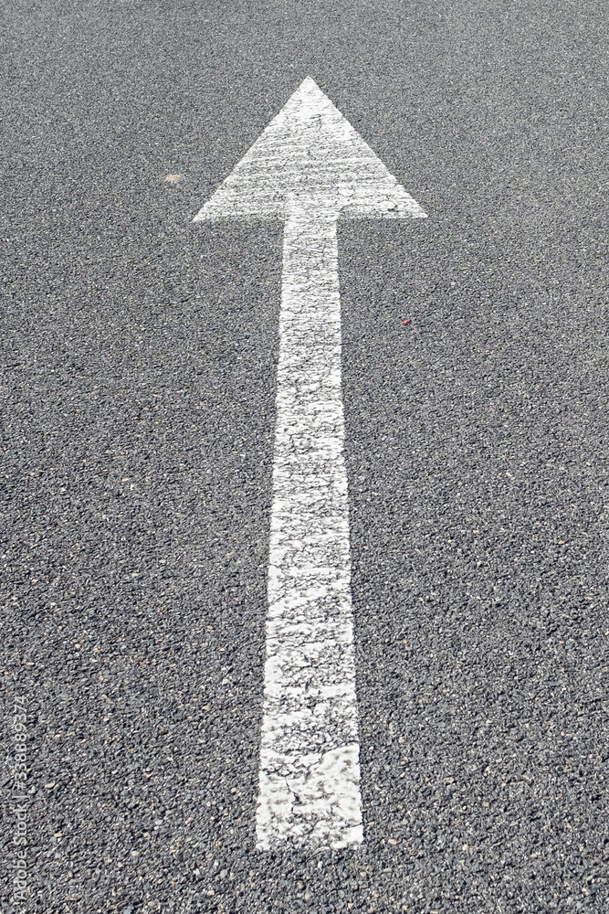 arrow sign on asphalt