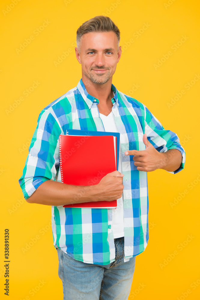 Teacher introduction. Free courses. Regular student carry workbooks. Student life. Dedicated to studying. Student with textbooks. College university education. Man adult student. Graduation concept Teacher introduction. Free courses. Regular student carry workbooks. Student life. Dedicated to studying. Student with textbooks. College university education. Man adult student. Graduation concept