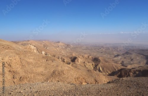 The desert landscape with many yellow sandstone mountains and the blue sky