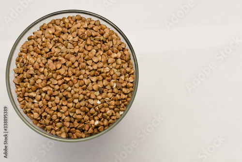 buckwheat groats on a light background, closeup texture