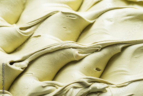 Pistachio flavour gelato - full frame detail. Close up of a creamy green surface texture of Pistachio Ice cream photo