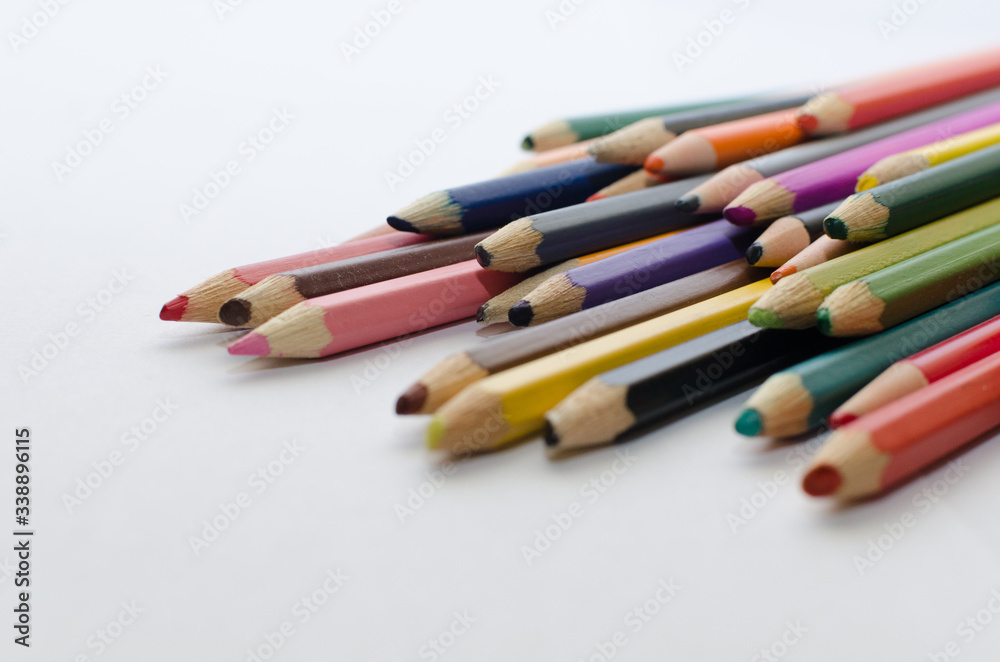 blunt colored pencils on a white background, sharpened pencil lead on a light background, close-up blunt colored pencils on a white background, sharpened pencil lead on a light background, close-up