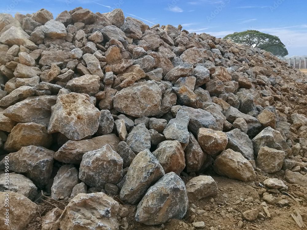 A big pile of limestone on the construction site. Industrial background with pile of gravel in front of the sky.