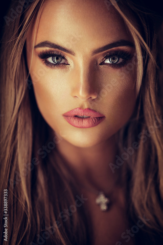 portrait of a beautiful lady with glamorous makeup on grey