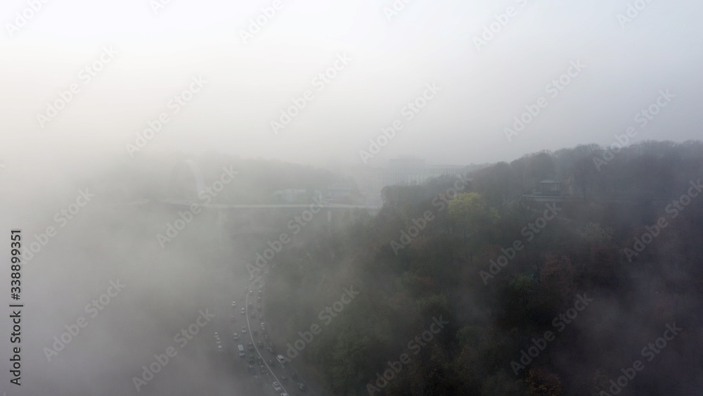 Fototapeta premium A city covered in fog. City traffic, aerial view