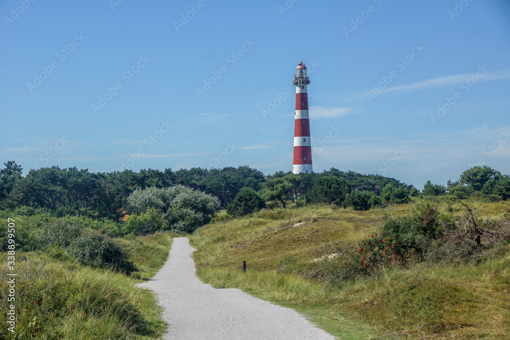 The red white lighthouse of the abandoned Ameland in the Netherlands The red white lighthouse of the abandoned Ameland in the Netherlands