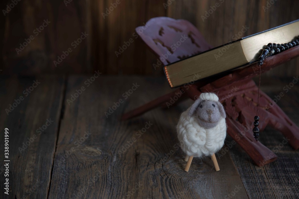 .toy lamb on wooden background..sacrifice feast concept .toy lamb on wooden background..sacrifice feast concept