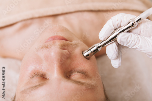 Close up shot of a man getting skincare facial treatment at beauty clinic
