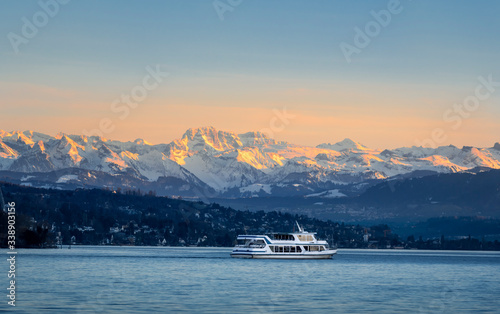 Empty cruise boat sailing on Zurich lake at sunset