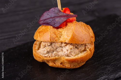 Canape with a pate of chicken, beef and duck, served in ecklers with greens photo