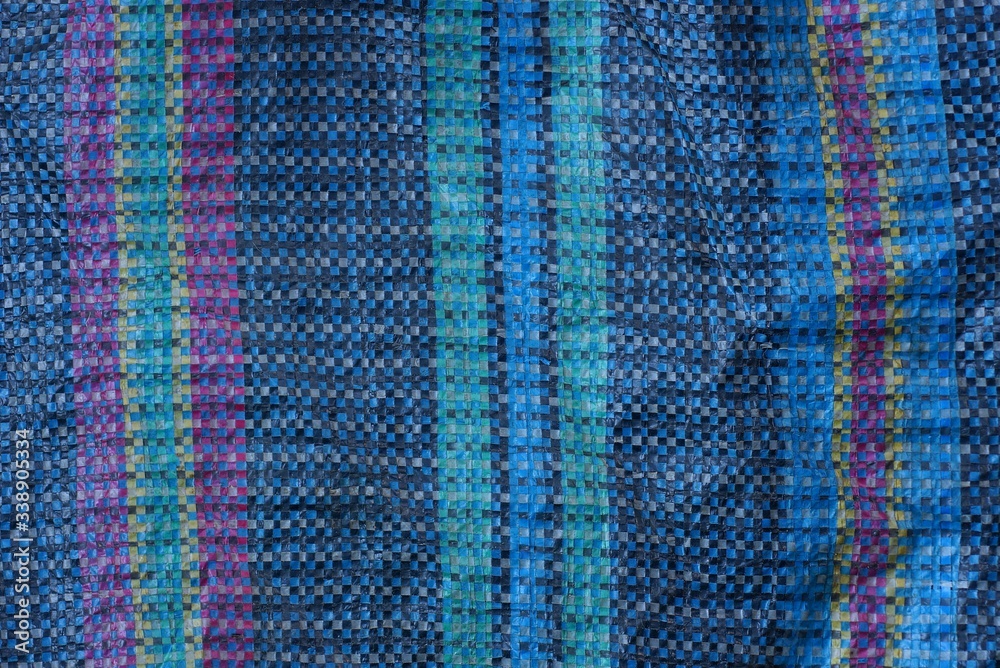 colored fabric texture from a piece of cloth on an old bag with a pattern colored fabric texture from a piece of cloth on an old bag with a pattern