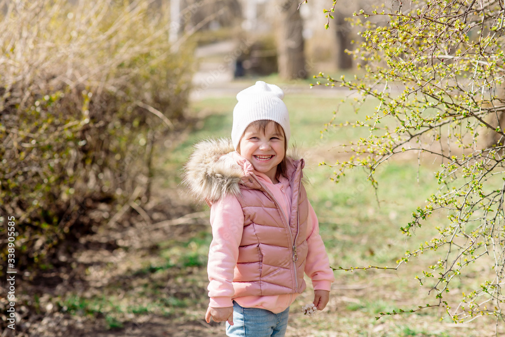Little girl walks in nature in the spring park Little girl walks in nature in the spring park