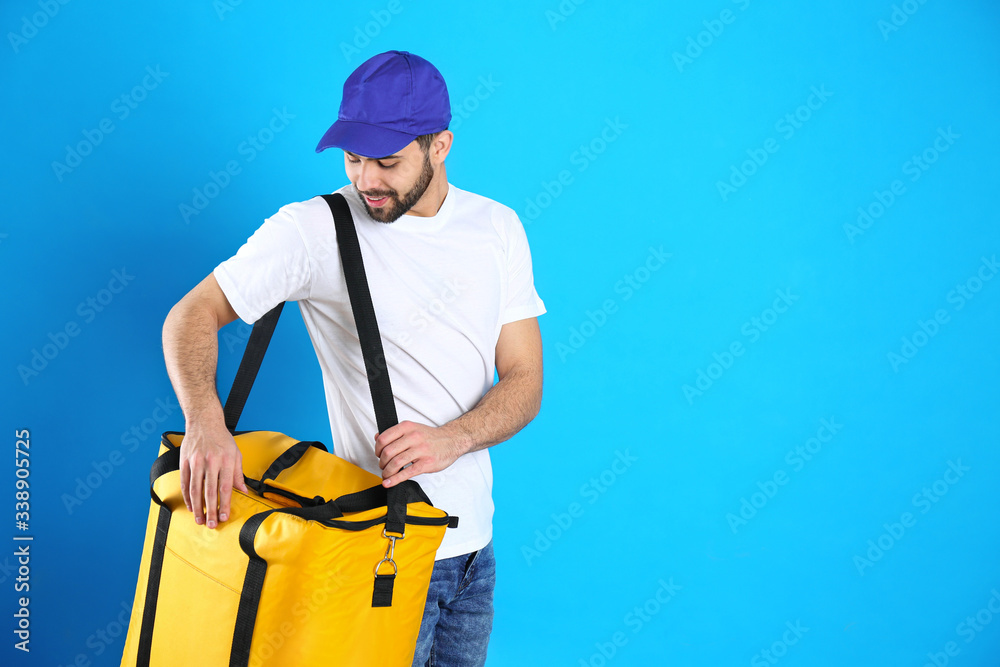 Courier with thermo bag on light blue background, space for text. Food delivery service Courier with thermo bag on light blue background, space for text. Food delivery service
