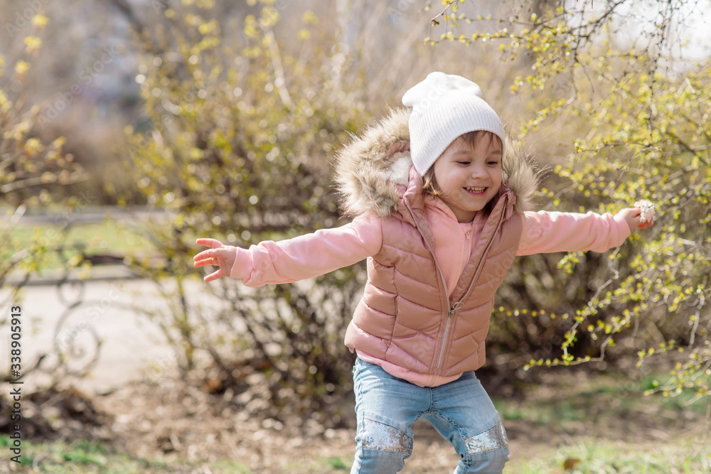 Little girl walks in nature in the spring park Little girl walks in nature in the spring park