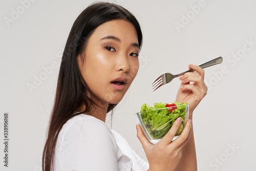 Beautiful woman of Asian appearance salad diet and health