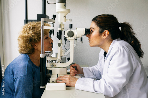 Ophthalmologist examining eyesight of a senior patient