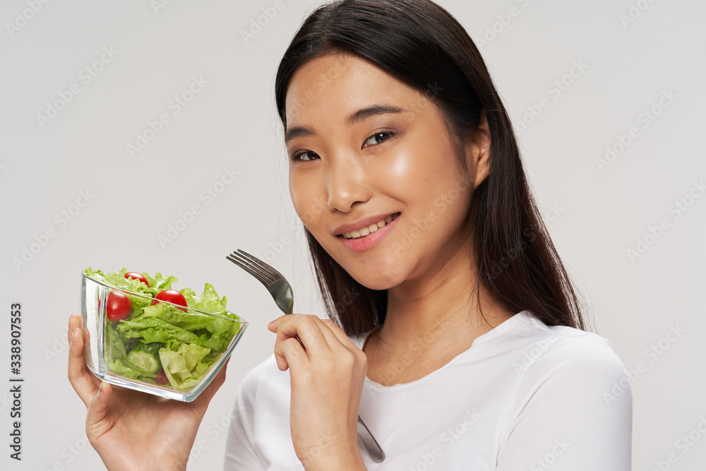 Cheerful woman Asian appearance salad meal Cheerful woman Asian appearance salad meal