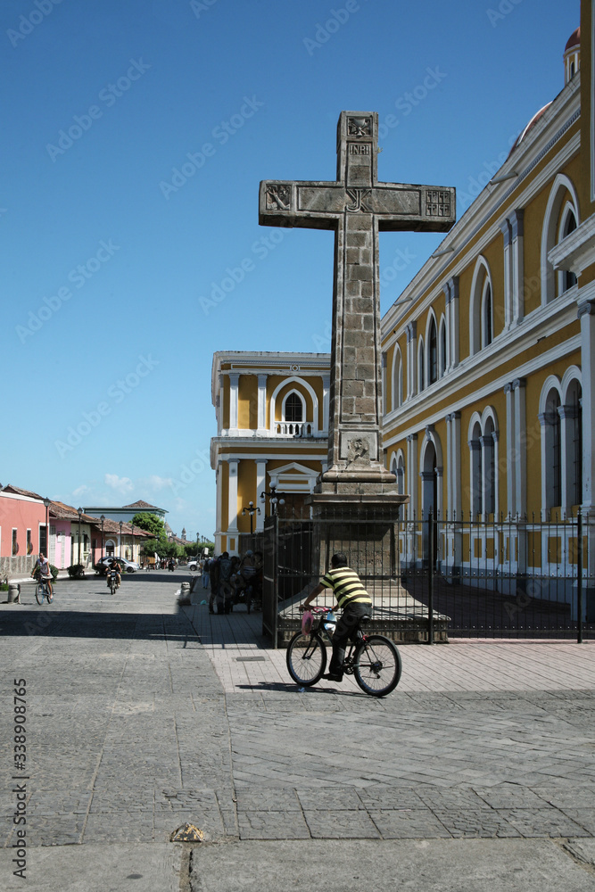 Man rides a bicycle in front of the Cathedral of Granada Nicaragua