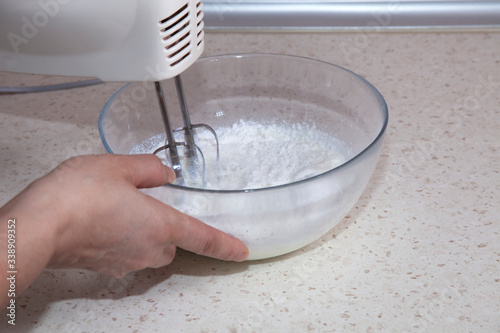 making whipped cream with a mixer in the kitchen