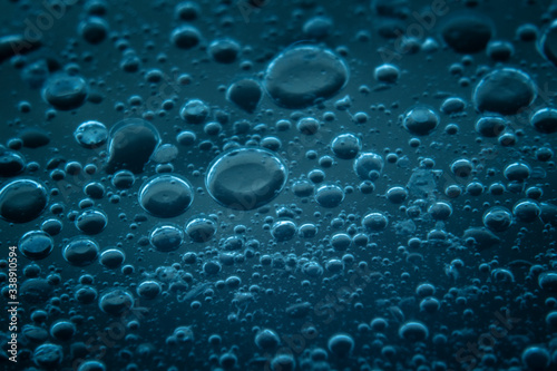 Macro shots cooking oil mixed with water on the glass surface 
