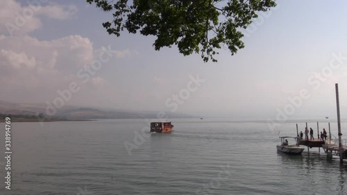 A boat is starting the cruise on the Sea of Galilee