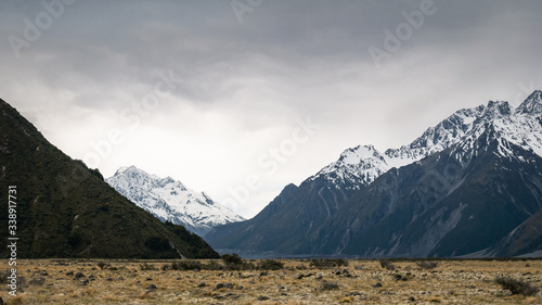 Vista on alpine valley during approaching storm with peaks covered by snow in backdrop, shot at Aoraki/Mt Cook National Park, New Zealand © Peter Kolejak