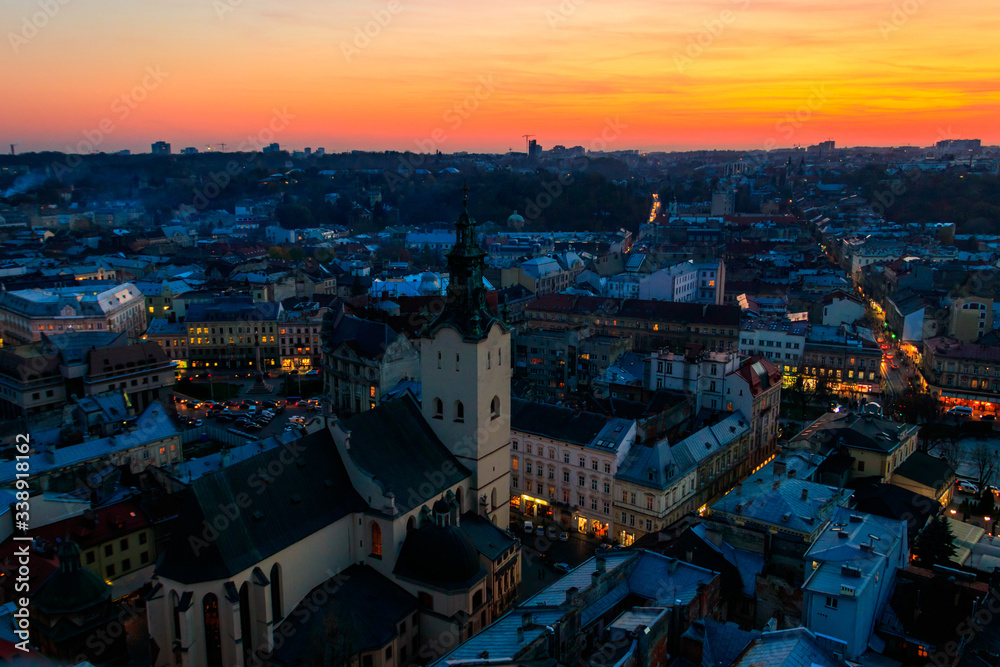 Naklejka premium Aerial view of Latin cathedral and Rynok square in Lviv, Ukraine at sunset. View from Lviv town hall