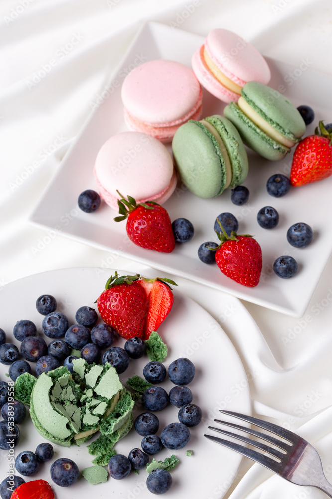 Macaroon pink and mint delicious with blueberries and strawberries and tea Macaroon pink and mint delicious with blueberries and strawberries and tea