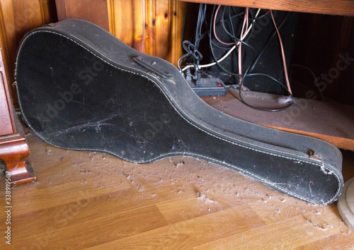 Old Guitar Lies Forgotten, Unplayed, and Covered in Dust photo