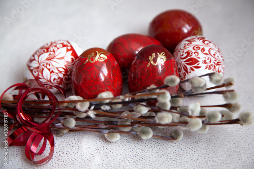 Easter eggs on a white background with a willow branch