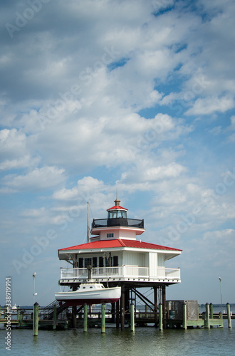 View of Choptank River Lighthouse in Cambridge, MD with dramatic blue, cloudy sky in background