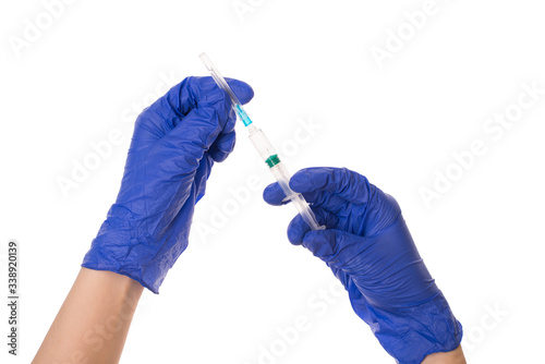 Preparing for the injection concept. Cropped close up photo of hands in blue latex gloves using syringe isolated over white background