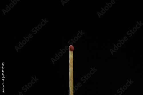 One match on the black background isolated side view