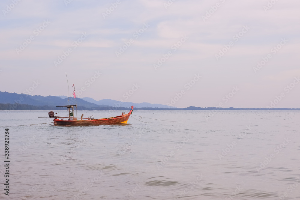 longtail boat standing near the shore at sunset.Beautiful sunset of fishing village in Phang Nga Bay with longtail wooden fishing boat ,Thailand.Travel by Asia. Landscape with traditional fishing boat longtail boat standing near the shore at sunset.Beautiful sunset of fishing village in Phang Nga Bay with longtail wooden fishing boat ,Thailand.Travel by Asia. Landscape with traditional fishing boat
