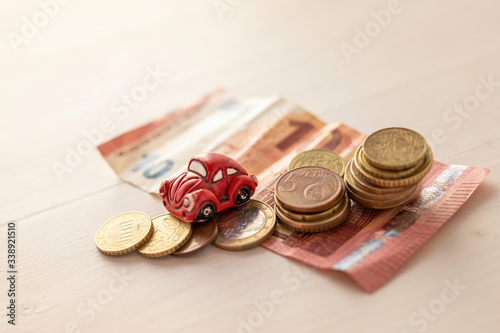 shaby vintage old broken small toy car on pile of euro money  photo