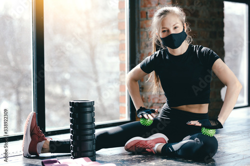 Coach mask pilates is resting. Sport activities during the quarantine. Massage roller, ball myofascial and pink ribbons for sport photo