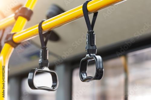 Yellow handrails and black handles to hold passengers steady while the bus is moving.